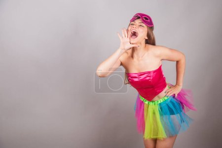 Téléchargez les photos : Femme blonde brésilienne vêtue de vêtements de carnaval rose. port de mascara, cris de promotion, publicité. - en image libre de droit