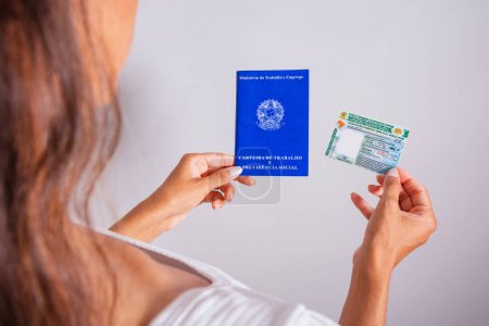 Photo for Hand holding driver's license and work and social security card, brazilian documents. - Royalty Free Image