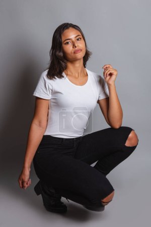 Photo for Beautiful Brazilian woman in white shirt, photo shoot. - Royalty Free Image