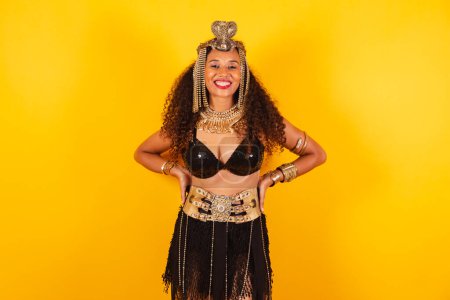 Photo for Horizontal, half body shot of beautiful black Brazilian woman in carnival clothes. hands on waist. - Royalty Free Image