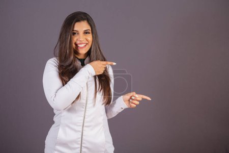 Photo for Horizontal photo. brazilian woman with medical coat, nutritionist. advertising on the right. - Royalty Free Image
