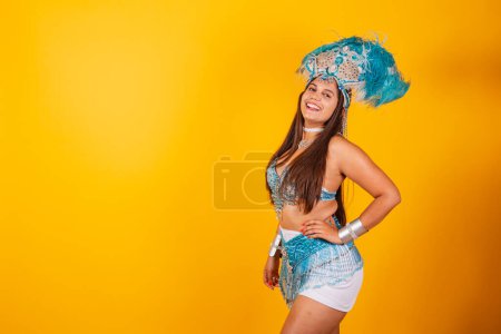 Foto de Hermosa mujer brasileña en ropa de carnaval azul y blanco. con plumas, sonriendo mirando a la cámara. mano en la cintura. - Imagen libre de derechos