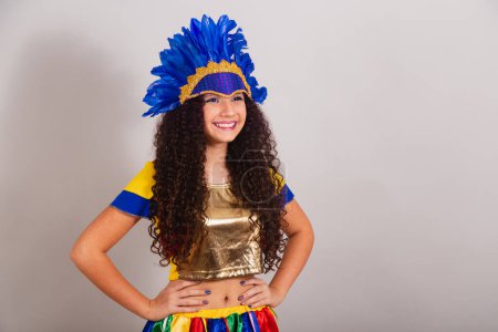 Foto de Jovencita adolescente, brasileña, con ropa frevo, carnaval. usar tocado de plumas posando para la foto. - Imagen libre de derechos