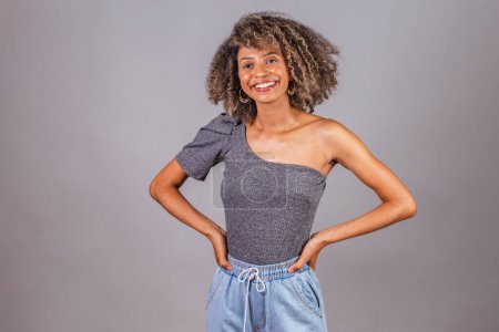 Photo for Black Brazilian woman, beautiful, with gray shirt and hands on her waist. - Royalty Free Image