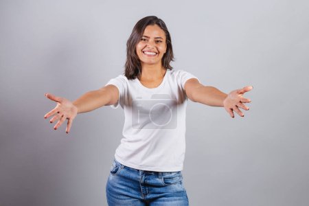 Photo for Beautiful brazilian woman. denim and white. with open arms for a hug. - Royalty Free Image