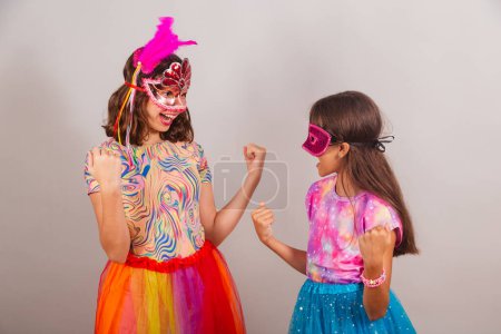 Photo for Two Brazilian children, girls, dressed in carnival clothes, celebrating. - Royalty Free Image