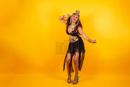 Photo for Horizontal photo, full body, Black Brazilian woman in carnival clothes. dancing. - Royalty Free Image