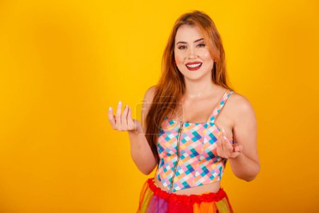 Photo for Brazilian redhead, in carnival clothes, inviting with hands. - Royalty Free Image