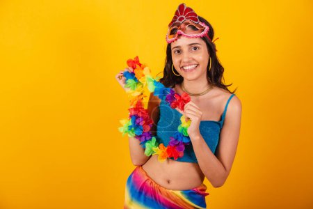 Photo for Beautiful brazilian woman in carnival clothes, wearing carnival mask and flower necklace. - Royalty Free Image