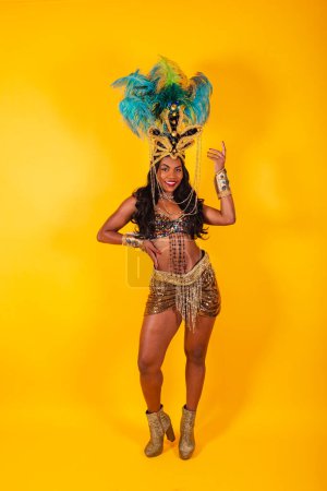Photo for Vertical photo, full body, Black Brazilian woman in carnival clothes posing for a photo. - Royalty Free Image