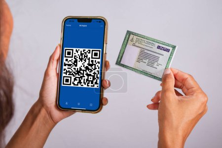 Photo for Hands holding identity card and smartphone. Apps. - Royalty Free Image