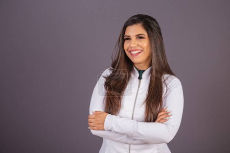 Photo for Horizontal photo. brazilian woman with medical coat, nutritionist. with arms crossed. - Royalty Free Image