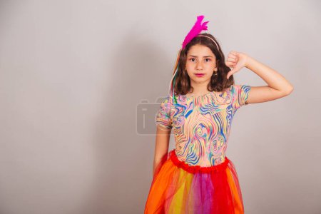 Photo for Brazilian child, girl, dressed in carnival outfit, sign of dislike with fingers. - Royalty Free Image