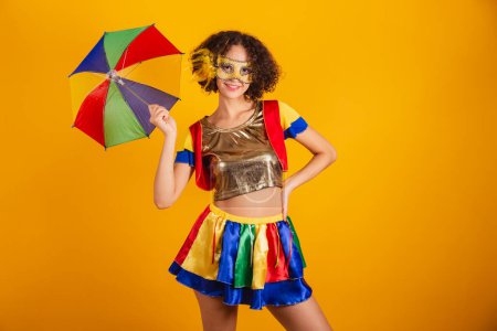 Photo for Beautiful Brazilian woman, dressed in frevo clothes, dressed for carnival. using colorful umbrella. - Royalty Free Image