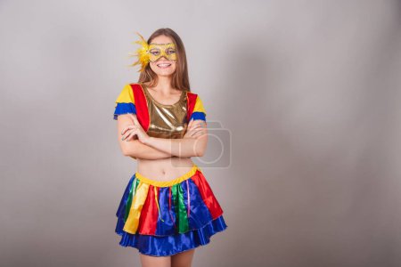 Photo for Brazilian blonde woman, dressed in frevo clothes, carnival mask and arms crossed. - Royalty Free Image