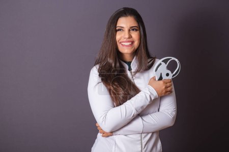 Horizontal photo. brazilian woman with medical coat, nutritionist. adipometer, slimming.