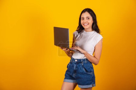 Photo for Beautiful brazilian woman holding notebook, working. - Royalty Free Image