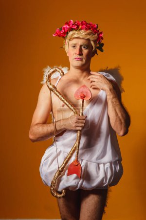 Photo for Valentine's day concept. Portrait of the God of love - Cupid with bow and arrow on a yellow background. - Royalty Free Image