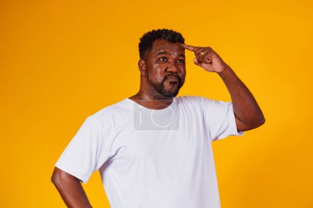 Photo for Afro man forgotten and confused on yellow background - Royalty Free Image
