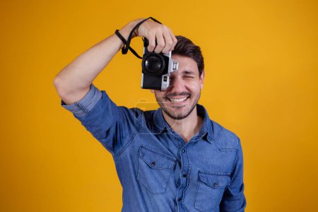 Photo for Cute photographer on yellow background. man with a photo camera - Royalty Free Image