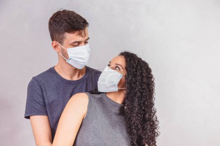 Photo for Young couple in love with medical mask - Royalty Free Image
