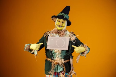 Photo for Photo of scarecrow character from festa junina on yellow backgro - Royalty Free Image