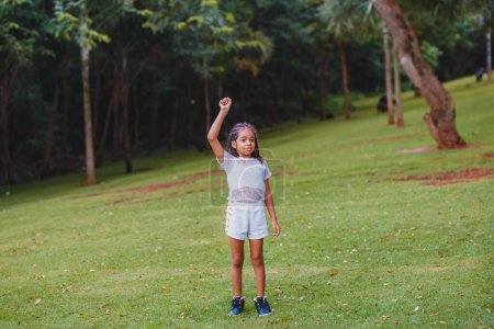Téléchargez les photos : Magnifique afro enfant dans le parc - en image libre de droit