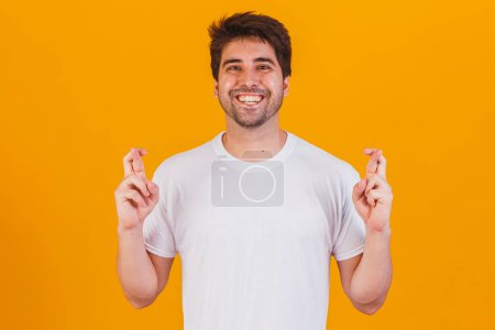 Photo for A portrair of a young man with crossed fingers - Royalty Free Image
