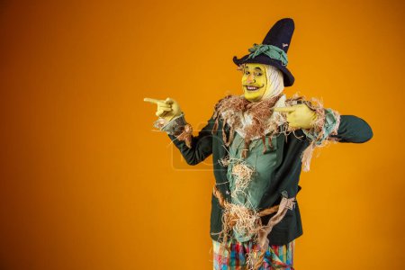 Photo for Photo of scarecrow character from festa junina on yellow backgro - Royalty Free Image