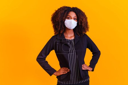 Photo for Young black model wearing protective mask. Beautiful black girl with great hair, wearing white protective mask. - Royalty Free Image
