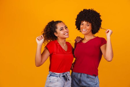 Photo for Young beautiful and happy afro female friends smiling to the camera. - Royalty Free Image
