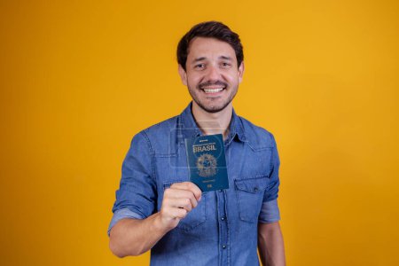 Photo for Young man holding a passport - Royalty Free Image