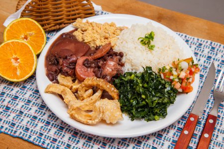 Photo for Feijoada, the Brazilian cuisine tradition.Delicious dish made of feijoada with crackling - Royalty Free Image