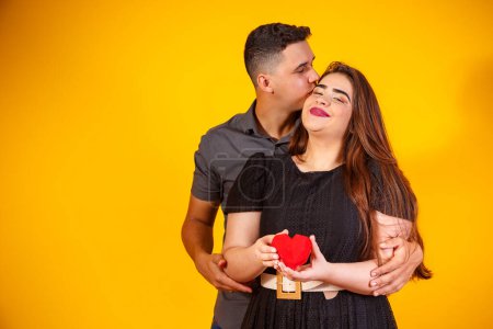 Photo for Young valentine couple holding a heart-shaped chocolate. couple holding a heart - Royalty Free Image
