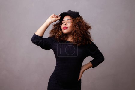 Photo for Afro woman with curly hair wearing beret and warm clothes. - Royalty Free Image