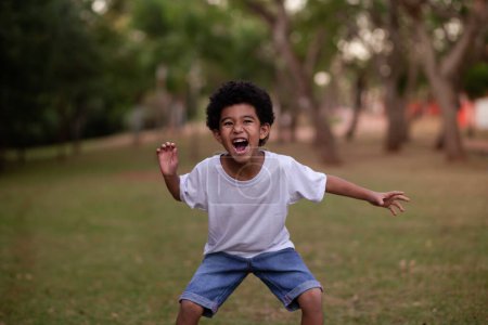 Photo for Little afro boy grimacing at camera - Royalty Free Image