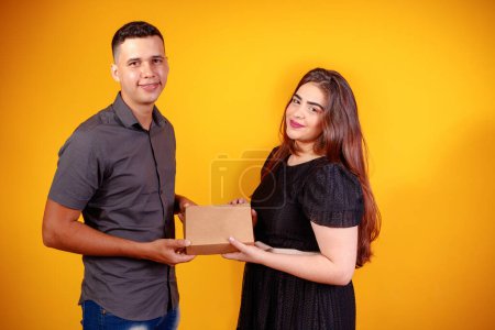 Photo for Young valentine couple with candy box making surprise. Gifts and valentines concept. - Royalty Free Image