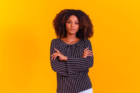 Photo for Beautiful curly-haired girl posing on yellow studio background. - Royalty Free Image