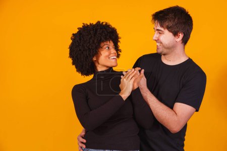 Photo for Portrait of content couple in basic clothing smiling at camera - Royalty Free Image