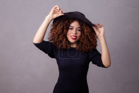 Téléchargez les photos : Femme afro portant un chapeau. Portrait studio de mode - en image libre de droit