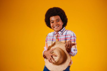 Photo for Portrait of a little boy afro wearing typical clothes for the Festa Junina - Royalty Free Image