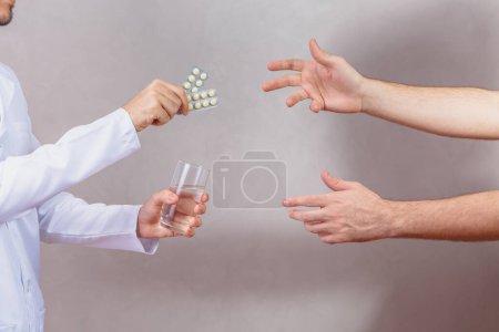 Photo for Doctor delivering medicine to patient who is in pain - Royalty Free Image