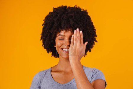 Photo for Afro woman with her hand covering half of her face - Royalty Free Image