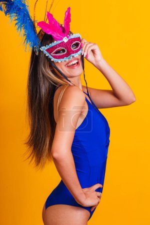Photo for Beautiful woman dressed for the carnival night. Smiling woman ready to enjoy the carnival with mask - Royalty Free Image