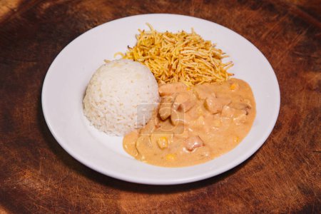 Photo for Food dish with chicken stroganoff and rice and chips - Royalty Free Image