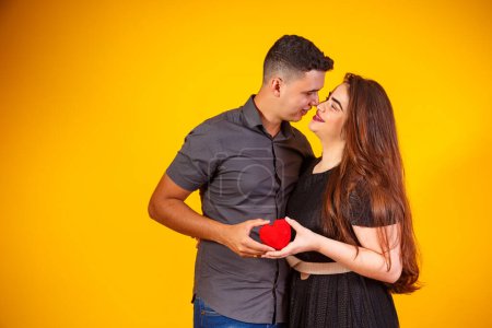 Photo for Young valentine couple holding a heart-shaped chocolate. couple holding a heart - Royalty Free Image