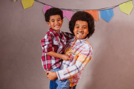 Photo for Afro brothers dressed in junina party clothes - Royalty Free Image