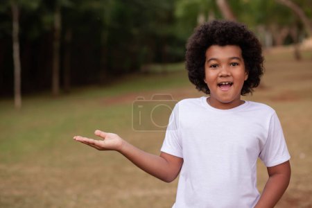 Photo for Afro boy with in the park with space for text. - Royalty Free Image