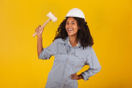 Photo for Female engineer holding a sledgehammer - Royalty Free Image