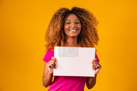 Photo for Woman shows empty board. Advertising board. Black friday. Advertising. Smiling woman holds empty advertising banner. Ready for your text. Sale and discount. Season sales. - Royalty Free Image